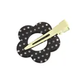 Detailed view of a floral acrylic hair clip with white polka dots on a green metal duckbill - Spotted Flower Black