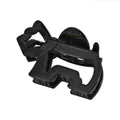 Macro shot of black acetate claw clip showing gold metal spring and brand logo engraving - Black