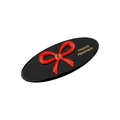 Detail eines schwarzen Acetat-Haarclips mit roter Schleife und France Handmade Logo - Schwarz