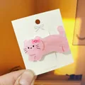Close-up of pink cat acrylic hair clip with stone texture on branding card - Pink Cat Duckbill Clip