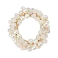 Macro shot of elastic hair tie featuring white faux pearls and faceted crystal beads - Cream