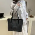 Large black tote bag with M-letter jacquard pattern and gold logo for daily commuting - Black