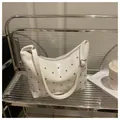 Detail of white patent leather shoulder bag with silver rivet studs and polished finish - White