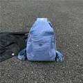 Light blue nylon casual backpack for women with front zipper pocket and metal logo - Blue