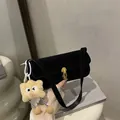 Black suede underarm shoulder bag featuring a gold buckle and cute plush charm - No Pendant / Black