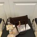 Retro dark brown suede underarm bag with gold twist lock and a cute plush charm - No Pendant / Dark Coffee