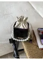 Detail der schwarzen Krokostruktur-Eimertasche mit Perlengriff und Satin-Kordelzug - Kaffeebraun