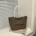 Dark brown canvas tote bag with black TOTE BAG print and woven rope handles - Brown