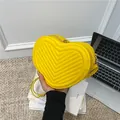 Vibrant yellow heart-shaped crossbody bag featuring V-shaped quilting and golden zipper - Yellow