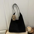 Black matte suede hobo bag with a plush dog charm and minimalist shoulder design - Black With Pendant