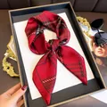 Elegant red plaid satin square scarf displayed on a black tray with stylish accessories - 70cmx70cm / Red
