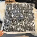 Detail of square silk scarf with black geometric chain pattern on cream satin fabric - LQ-16