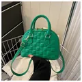 Green shell bag with embossed grid pattern and gold hardware for crossbody use - Green