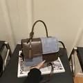 Retro patchwork handbag in brown leather and denim blue fabric with top handle - Brown