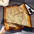 Detailed view of square silk scarf with vintage paisley print in brown and yellow tones - Gold