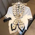 Polka dot satin silk scarf with black knit top shown on elegant leather surface - 90x90cm / Cream Black Polka Dot (SJ2611-12)