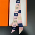 Pink and blue geometric floral silk twilly scarf displayed in a classic orange gift box - Long Ribbon / Pink Blue Geometric (C310-3)