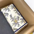 Close-up of floral cashmere feel scarf with vintage prints and delicate fringe details - Beige Blue
