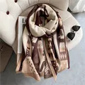 Thick geometric winter scarf with fringe in caramel and cream colors on a cozy chair - 180x65cm / Coffee