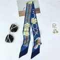 Elegant blue floral silk twilly scarf with yellow flower patterns and horse motifs - Blue