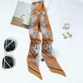 Detail of orange zebra pattern twilly scarf with satin texture and washing label - 100x6cm / Ginger Yellow