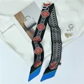 Detail of skinny black scarf with silver chain print and colorful silk texture accents - Black
