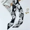 Narrow silk neck scarf with white camellia flower patterns on black satin background - Black