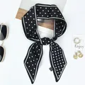 Polka dot silk scarf tied in a bow with fashion accessories on a white background - 100x6cm / Black and White