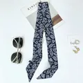Navy paisley silk scarf for hair or bags displayed with sunglasses and magazine - 100x6cm / Navy Blue