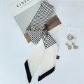 Off-white skinny twilly scarf with black geometric stripes and diagonal pointed ends - White