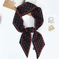Fashionable black and red polka dot silk twilly scarf tied in a bow on white background - 100x6cm / Black Red