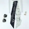 Detail of a black and white Gemini zodiac silk scarf showing the starry night pattern - Gemini