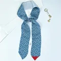 Detailed view of blue geometric pattern faux silk twilly scarf with security tag - Color 7 (Blue Geometric Floral)