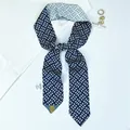 Detail of navy and white geometric silk scarf with 100% polyester care label and accessories - Color 4 (Navy White Rhombus)