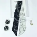 Close-up of Taurus zodiac pattern on black and white silk twilly scarf with constellations - Taurus