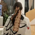Retro silk-like floral skinny scarf tied as hair ribbon on ponytail in cozy home setting - 120x8CM / Coffee Brown Retro Floral (Color 3)