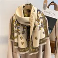 Dettaglio motivo floreale a farfalla e frange di nappe su scialle spesso color crema - 180x65cm / Blu-Giallo