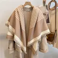 Detailed view of camel striped cashmere shawl with elegant fringe and soft texture - Khaki