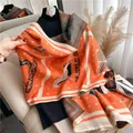 Detail of cashmere-like shawl with horse carriage patterns and fine fringe finish - Orange
