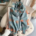 Detailed view of the butterfly pattern and soft tassel edges on the blue cashmere scarf - Light Blue