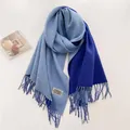 Primer plano detallado de la bufanda de cachemira azul degradado con flecos y etiqueta de marca - Azul Profundo y Azul Claro