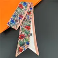Elegant floral silk hair ribbon in pink and blue on an orange signature backdrop - Pink