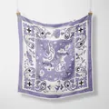 Detalle de pañuelo de seda cuadrado en violeta y blanco con motivos paisley y cowboy - Morado