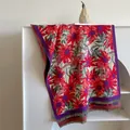 Ethnic style floral shawl with red flowers and grey tassels on a white display rack - Retro Floral Style / Beige Red Floral