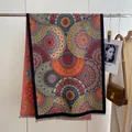 Ethnic mandala print shawl with fine fringe detail hung in a lifestyle setting - 190x65cm / Boho