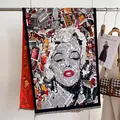 Detail of artistic Marilyn Monroe collage print shawl with fringe on a sleek display - Artistic Portrait Style / Newspaper Collage