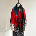 Detailed macro view of Chinese style bamboo print and tassels on a thick knitted shawl - Red Black Blue White Patchwork