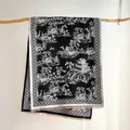 Detailed view of classical landscape print and delicate tassel edges on a warm shawl - 185x65cm / Black and White