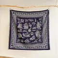 Macro detail of nautical cashew floral print scarf with soft fringe edges and sailing ship pattern - Blue