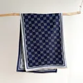 Detailed view of dark blue scarf with geometric floral pattern and soft fringe edges - 185x65cm / Blue